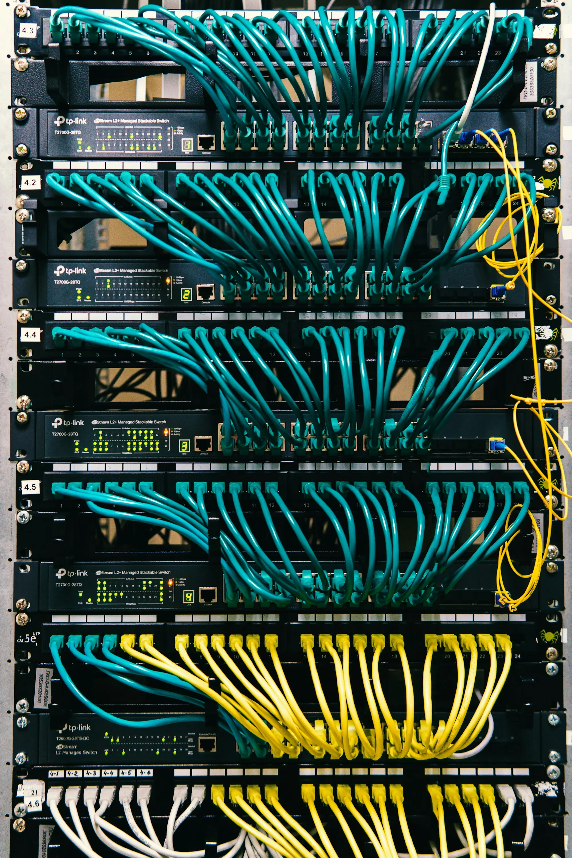 Network cables patched into the ports of a server rack